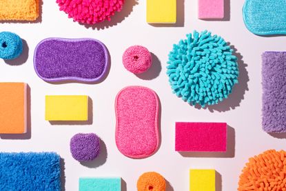spring cleaning concept with colorful cleaning sponges and cloths